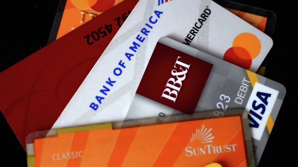 This illustration picture shows debit and credit cards arranged on a desk on April 6, 2020 in Arlington, Virginia, US.  - Sputnik International