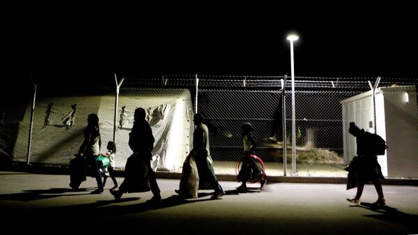 Migrants walk towards to the gate after arriving at a refugee camp from RAF Dhekelia - Sputnik International