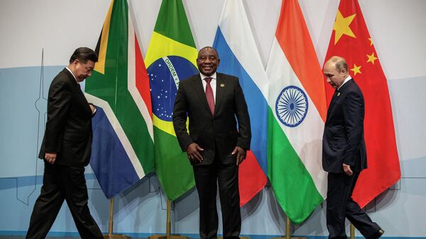 (LtoR) China's President Xi Jinping, South African President Cyril Ramaphosa and Russian President Vladimir Putin gather to pose for a group picture during the 10th BRICS (acronym for the grouping of the world's leading emerging economies, namely Brazil, Russia, India, China and South Africa) summit on July 26, 2018, at the Sandton Convention Centre in Johannesburg, South Africa. - Sputnik International