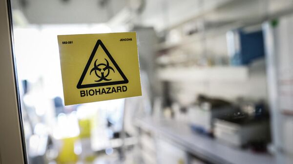 A biohazard sticker on the entrance of a laboratory. - Sputnik International