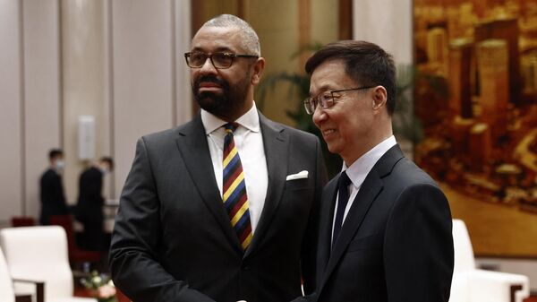 British Foreign Secretary James Cleverly (L) and Chinese Vice President Han Zheng shake hands before a meeting at the Great Hall of the People in Beijing - Sputnik International