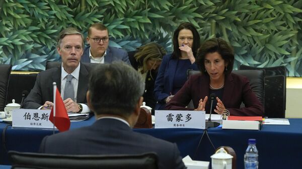 US Commerce Secretary Gina Raimondo (R) speaks next to US Ambassador to China Nick Burns (L) during a meeting with China’s Minister of Commerce Wang Wentao - Sputnik International