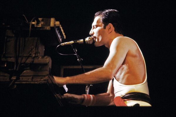 At that time he decided to change his surname from Farrokh Bulsara to Freddie Mercury for he believed Mercury to be his patron planet. Pictured in the photo above: Freddie Mercury performing at the Palais Omnisports in 1984.  - Sputnik International