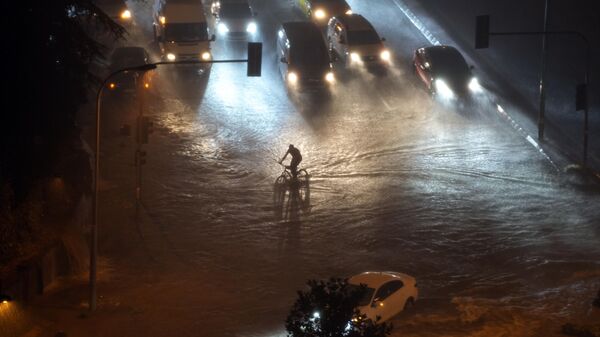 A cyclist rides through floodwater blocking the road due to heavy rain in Basaksehir district of Istanbul, Turkiye, Tuesday, Sept. 5, 2023. Flash floods triggered by heavy rains swept through a campsite in northwest Turkiye on Tuesday, killing at least two people, officials said. Four other people were reported missing.  - Sputnik International
