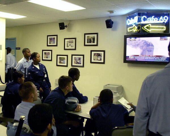 Onboard the aircraft carrier USS EISENHOWER, US Navy Sailors watch televised news reports, showing the World Trade Center, during the terrorist attacks. - Sputnik International