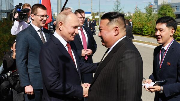 Russian President Vladimir Putin welcomes North Korean leader Kim Jong Un at the Vostochny Cosmodrome, September 13, 2023. - Sputnik International