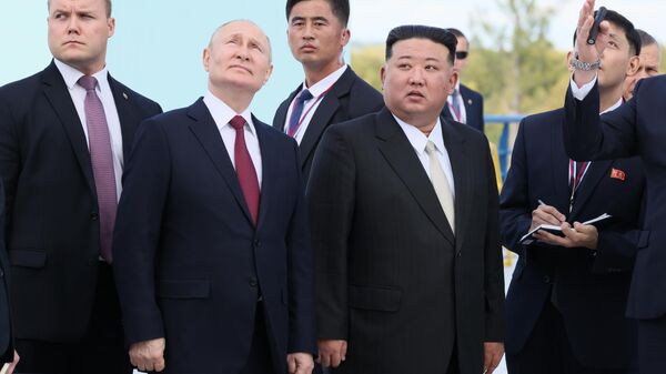 Russian President Vladimir Putin meets North Korean leader Kim Jong Un at the Vostochny Cosmodrome on September 13, 2023. - Sputnik International