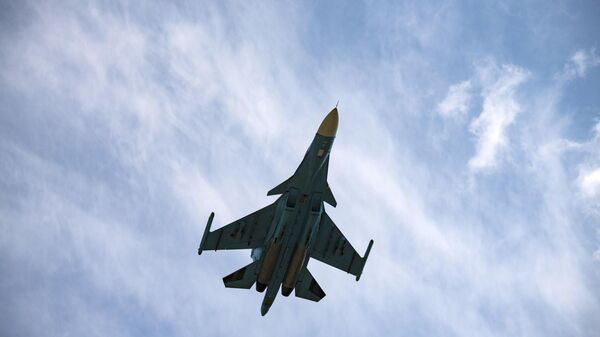 A Russian Sukhoi Su-34 fighter jet flies in the course of Russia's military operation in Ukraine, at the unknown location. - Sputnik International