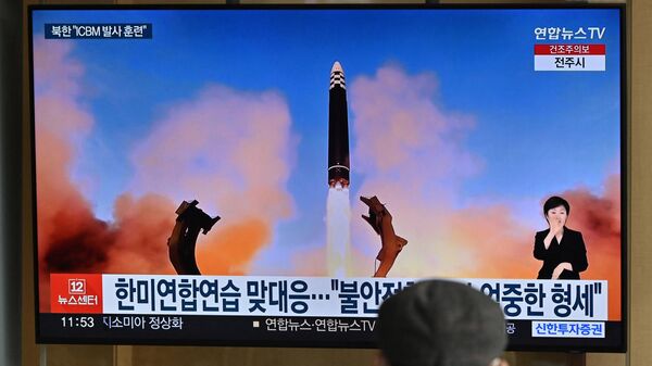 A man watches a television news screen showing a picture of North Korea's recent test-firing of a Hwasong-17 intercontinental ballistic missile (ICBM), at a railway station in Seoul on March 17, 2023 - Sputnik International