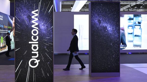 A visitor walks past the stand of American multinational corporation Qualcomm at the Mobile World Congress (MWC), the telecom industry's biggest annual gathering, in Barcelona on March 2, 2023. - Sputnik International