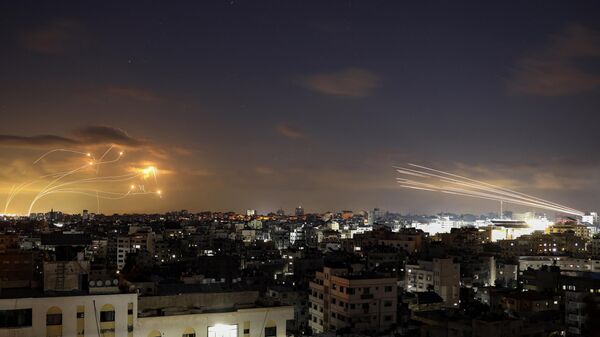 Rockets fired from the Gaza City (R) being intercepted by Israel's Iron Dome defence missile system (L) on October 10, 2023.  - Sputnik International