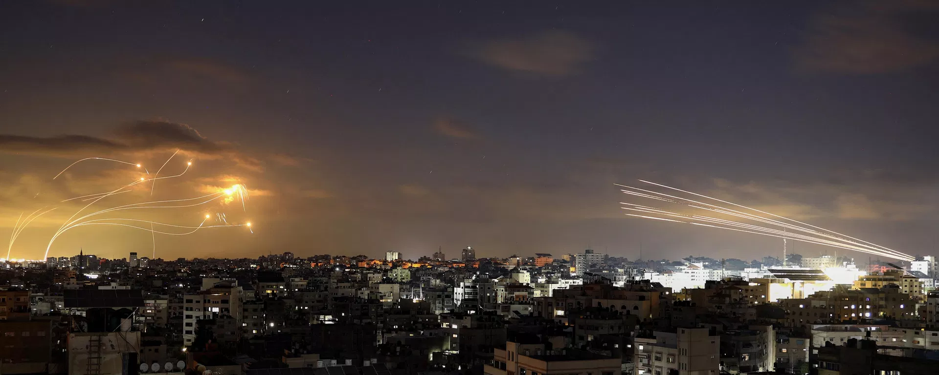 Rockets fired from the Gaza City (R) being intercepted by Israel's Iron Dome defence missile system (L) on October 10, 2023.  - Sputnik International, 1920, 12.10.2023