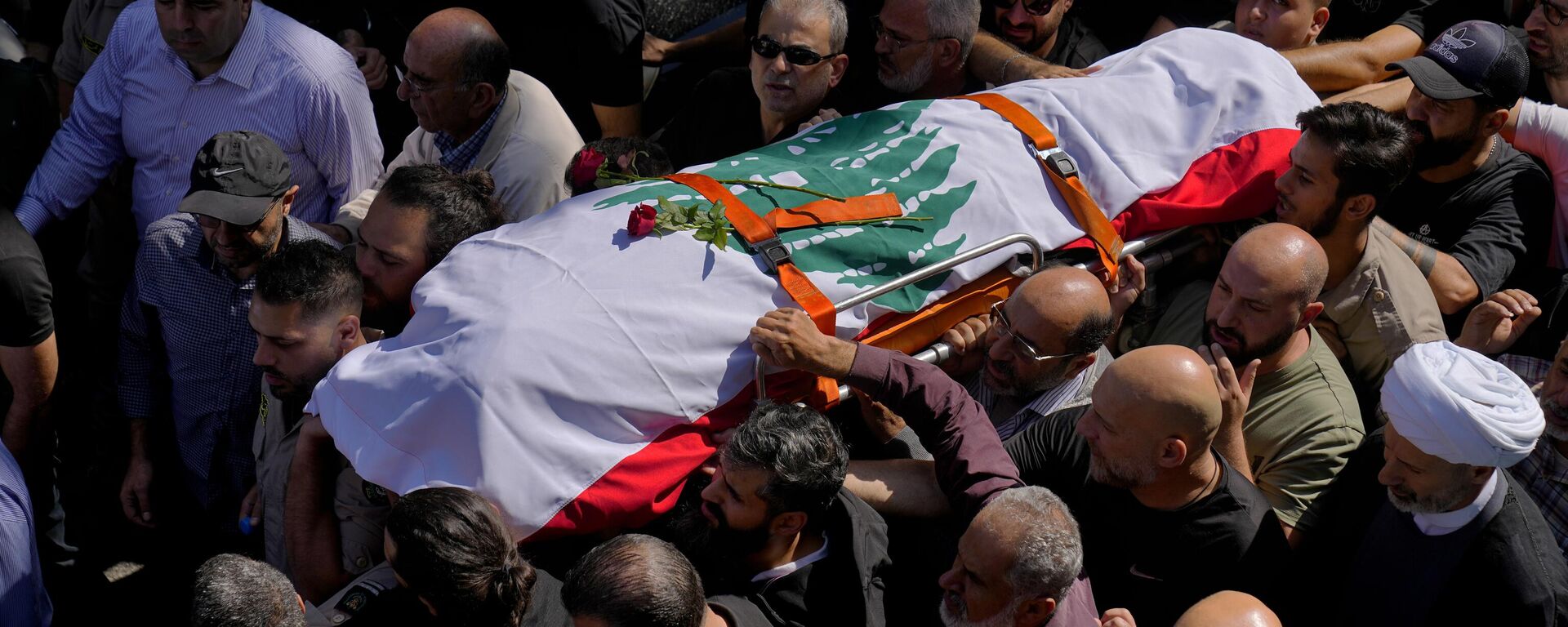 Mourners carry the body of Reuters videographer Issam Abdallah who was killed by Israeli shelling during his funeral procession in his hometown of Khiam, southern Lebanon, Saturday, Oct. 14, 2023 - Sputnik International, 1920, 03.11.2023