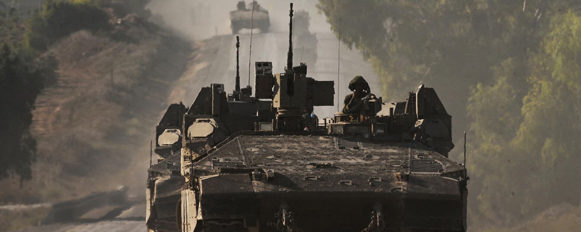 Israeli army armoured vehicles roll towards the border with the Gaza Strip at an undisclosed location in southern Israel on October 15, 2023. - Sputnik International, 1920, 15.10.2023