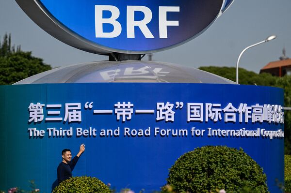A man poses next to an installation of the Third Belt and Road Forum for Int&#x27;l Cooperation in Beijing.  - Sputnik International