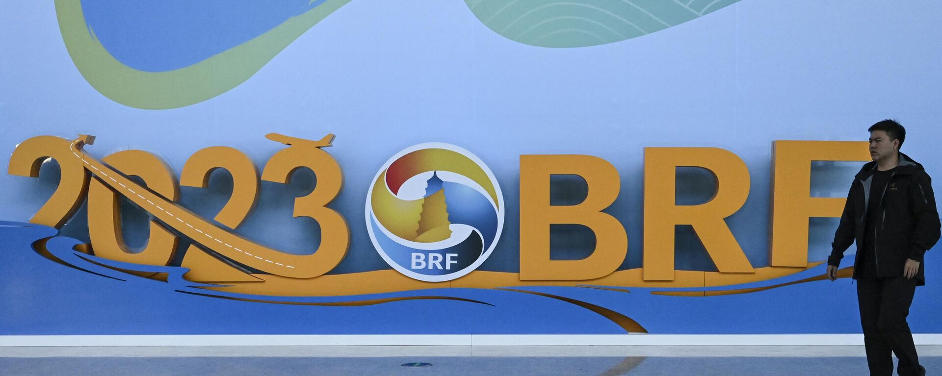 A man walks past the logo of the Belt and Road Forum at the National Convention Center in Beijing on October 15, 2023. - Sputnik International, 1920, 17.10.2023