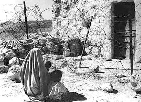 This picture dated 1948 shows a Palestinian woman refugee and her child separated from their home by the Green Line after the 1948 war.The Green Line was the armistice line established in 1949 at the end of the 1948 Arab-Israeli War, also known as the War of Independence. It played a significant role in shaping the geopolitical landscape of Israel and the Palestinian territories. The Line became a result of armistice agreements negotiated between Israel and its neighboring Arab states, including Egypt, Jordan, Syria, and Lebanon. These agreements were brokered by the United Nations and were intended to bring a temporary halt to hostilities and create a demarcation line separating the warring parties. The armistice agreements were signed between February and July 1949, effectively ending the major combat operations of the 1948 war. The Green Line was established during this period, and it marked the de facto borders between Israel and the neighboring Arab states at that time. The Green Line was not a permanent border or an internationally recognized boundary. It was simply a demarcation line, often drawn on maps in green ink, to represent the position of Israeli and Arab forces at the time the armistice agreements were signed.The Line divided the former British Mandate of Palestine into two main areas: Israel on one side and the West Bank (controlled by Jordan) and the Gaza Strip (controlled by Egypt) on the other. This division had a profound impact on the future of the Israeli-Palestinian conflict.The border&#x27;s line became a central point of reference in subsequent negotiations and discussions regarding the Israeli-Palestinian conflict. It played a role in defining the borders of Israel following its declaration of statehood in 1948 and was the starting point for discussions about the status of Palestinian territories in the years that followed. Palestinians commemorate 14 May the 50th anniversary of the &quot;Nakba&quot; [&#x27;catastrophe&#x27;, in Arabic) marking the creation of Israel and the exodus of 700 000 Palestinian refugees from their land.The Green Line represents a physical reminder of the displacement and division caused by the 1948 war. It still exists in historical and political contexts, but is not a recognized international border. - Sputnik International
