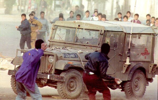 Palestinian youths hurl rocks at an Israeli army jeep during heavy clashes that erupted March 9, 1993, following the killing of an Arab worker by a settler on March 8.During that time, the Palestine-Israel conflict was ongoing, with tensions running high in the West Bank and Gaza Strip. Israeli settlements had been established in the occupied territories, leading to friction and disputes between Israeli settlers and Palestinian residents.The Palestinian youth threw rocks at Israeli soldiers as a form of protest and resistance against the killing of the Arab worker by an Israeli settler. Such actions were a common response to incidents of violence and perceived injustices by Israeli authorities and settlers. The throwing of stones was seen as an act of defiance and resistance to Israeli occupation. - Sputnik International
