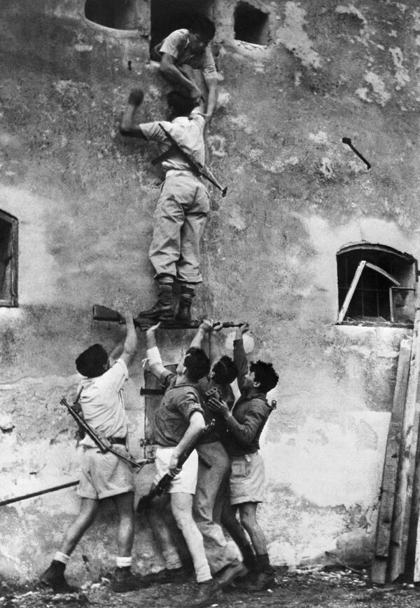 Haganah fighters scale a house in June 1948 in Tel Aviv.The Haganah was a Jewish paramilitary organization that operated in British Mandate Palestine from the early 1920s until the establishment of the State of Israel in 1948.The Haganah, which means &quot;Defense&quot; in Hebrew, was founded in 1920 as a self-defense organization by Jewish residents of Palestine during the period of British rule.The Haganah was created in response to the increasing violence and tensions between Jewish and Arab communities in Palestine during the early 20th century. The Arab riots of 1920 and 1921 highlighted the vulnerability of Jewish communities, leading to the formation of the Haganah to provide protection.The primary goal of the Haganah was to defend Jewish communities in British Mandate Palestine against various threats, including Arab violence, as well as to prepare for the eventual establishment of a Jewish state. While its primary focus was on self-defense, it also played a role in illegal immigration and clandestine arms acquisition.The Haganah engaged in a wide range of activities, including training its members, acquiring weapons, and establishing intelligence networks. It also cooperated with other Jewish underground organizations, such as the Irgun and Lehi, during the struggle for Jewish statehood.With the establishment of the State of Israel in 1948, the Haganah transitioned into the Israel Defense Forces (IDF), becoming the core of Israel&#x27;s military establishment. Many former Haganah members became key figures in Israel&#x27;s military and political leadership.Its legacy lives on in the history of Israel and its role in the struggle for statehood. The IDF, in essence, carries on the traditions and functions of the Haganah as the military of the State of Israel. The Haganah played a pivotal role in the establishment of Israel and the defense of Jewish communities during a critical period in the nation&#x27;s history. - Sputnik International