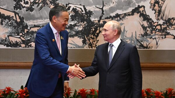Thai Prime Minister Settha Thavisin and Russian President Vladimir Putin shake hands before their meeting as part of the 3rd Belt and Road Forum at the Diaoyutai State Guest House in Beijing, China. - Sputnik International