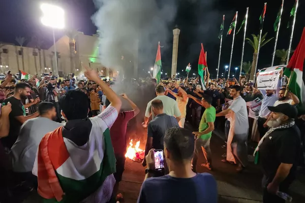 Crowds burn an American flag during a protest in Libya's capital, Tripoli, late on October 17, 2023, in support of the Palestinians following the missile strike on Gaza's Ahli Arab hospital which killed hundreds. Israel and the Palestinians have traded blame for the incident.  - Sputnik International