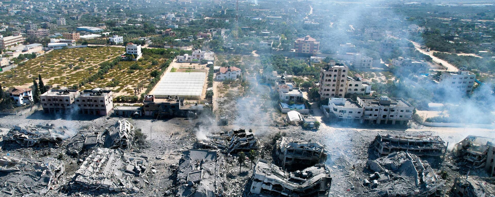 An aerial view shows destoyed buildings in al-Zahra south of Gaza City on October 20, 2023 following Israeli bombardment overnight amid ongoing battles between the IDF and the Palestinian group Hamas.  - Sputnik International, 1920, 30.10.2023