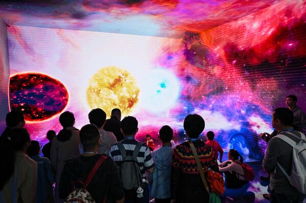 Visitors gazing at a visual exhibition during the 2023 World Science Fiction Convention. - Sputnik International