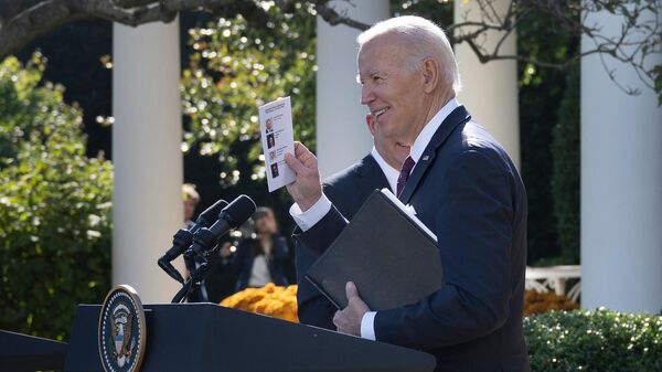 US President Joe Biden and Australia's Prime Minister Anthony Albanese (behind) leave after a joint press conference at the Rose Garden of the White House in Washington, DC, on October 25, 2023. Paper shows names and photos of journalists Biden would ultimately end up calling on. - Sputnik International