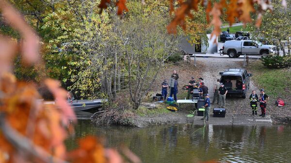 Law enforcement officials prepare to search the Androscoggin River in Lisbon Falls, Maine, on October 27, 2023, in the aftermath of a mass shooting in Lewiston, Maine. Police in Maine struggled for a second day on October 27, 2023, to catch a man who gunned down 18 people with a semi-automatic rifle in a bowling alley and a bar in a town where locals were enjoying an evening out. Robert Card, 40, is accused of being the man seen on security cameras walking into a Lewiston bowling alley on the evening of October 25, 2023, and launching the country's deadliest mass shooting of the year so far. In addition to the 18 murdered at the bowling venue and later in a bar, the US Army reservist is accused of wounding 13. - Sputnik International