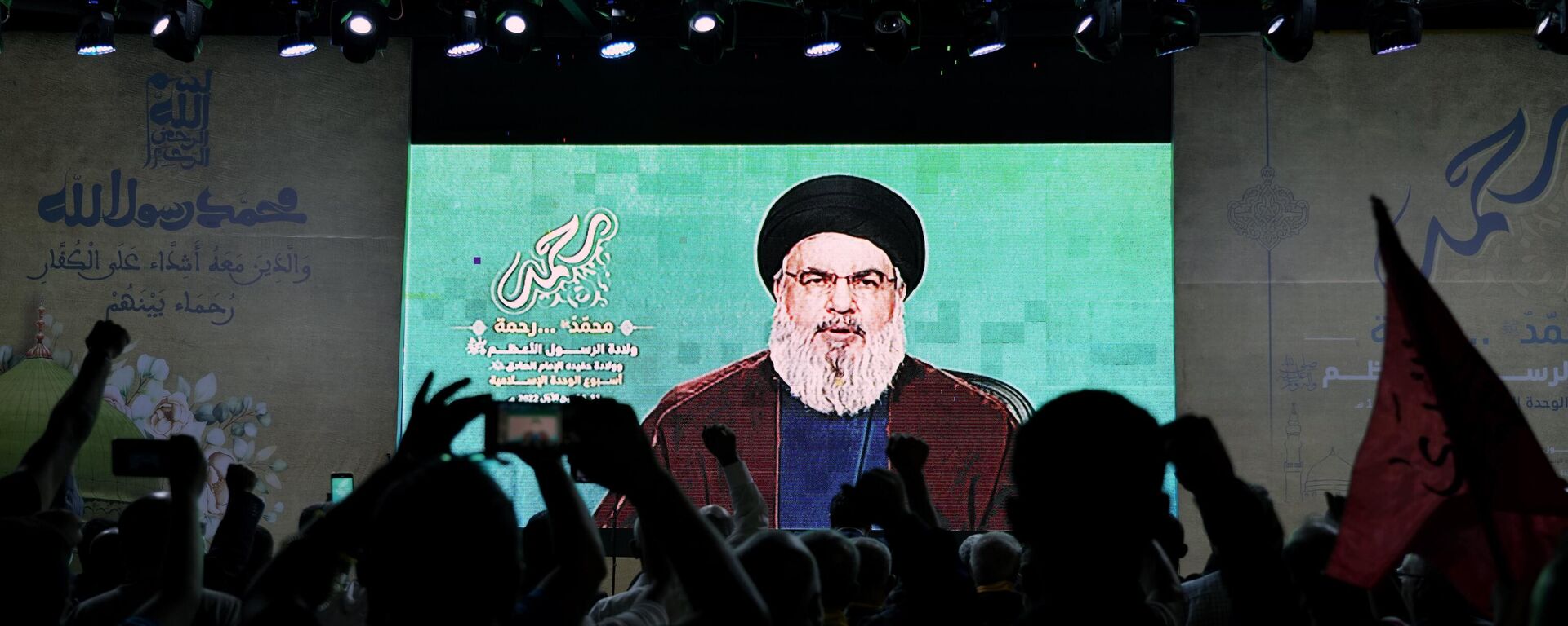 Supporters of the Hezbollah group raise their fists and cheer as they listen to a speech by Hezbollah leader Sayyed Hassan Nasrallah via a video link - Sputnik International, 1920, 03.11.2023