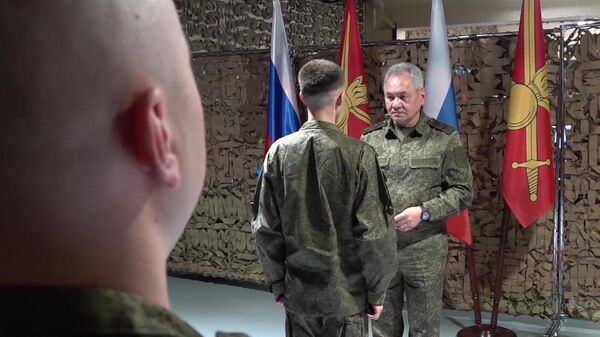 In this handout video grab released by the Russian Defense Ministry, Russian Defense Minister Sergei Shoigu presents a state award to a participant of the Russia's military operation - Sputnik International