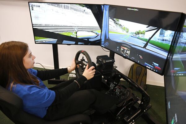 RUSSIA EXPO visitor drives a car on a simulator - Sputnik International