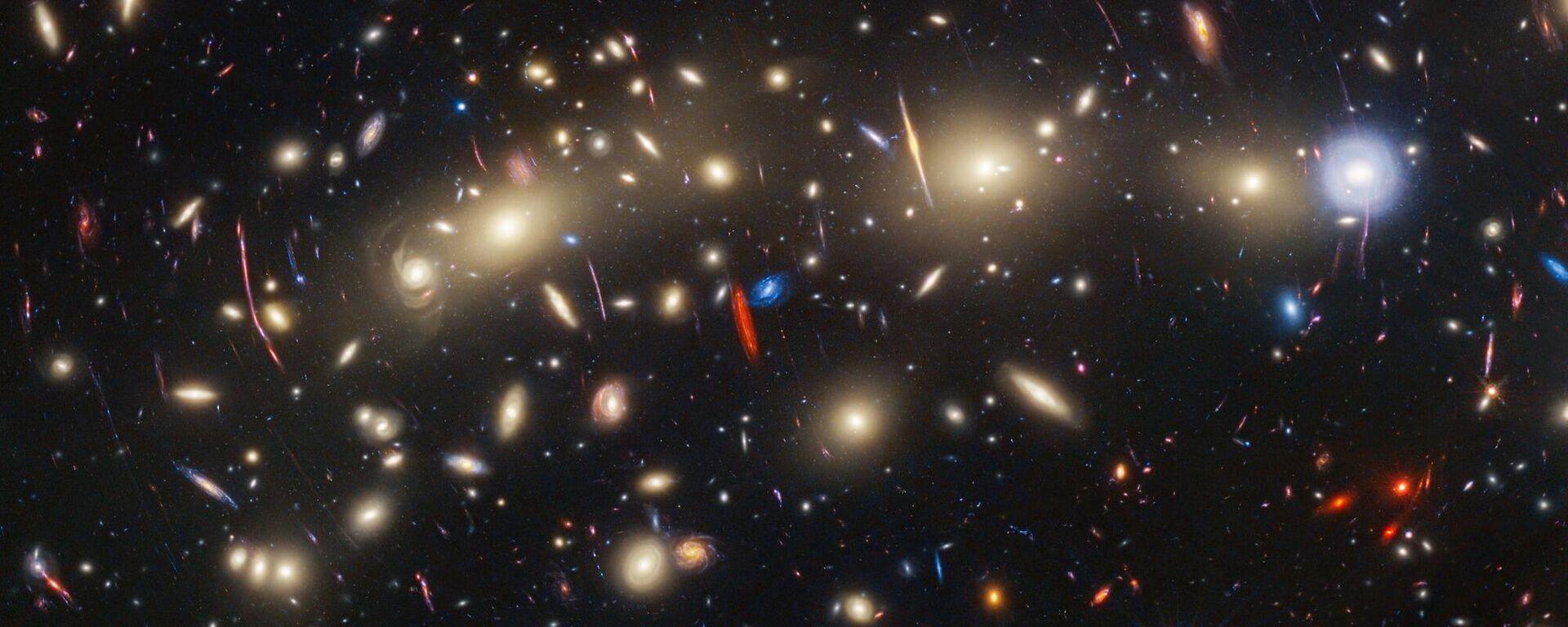 This image of galaxy cluster MACS0416 highlights one particular gravitationally lensed background galaxy, which existed about 3 billion years after the big bang. That galaxy contains a transient, or object that varies in observed brightness over time, that the science team nicknamed “Mothra.” Mothra is a star that is magnified by a factor of at least 4,000 times. The team believes that Mothra is magnified not only by the gravity of galaxy cluster MACS0416, but also by an object known as a “milli-lens” that likely weighs about as much as a globular star cluster. - Sputnik International, 1920, 09.11.2023