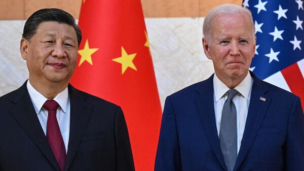 US President Joe Biden (R) and China's President Xi Jinping (L) meet on the sidelines of the G20 Summit in Nusa Dua on the Indonesian resort island of Bali on November 14, 2022 - Sputnik International