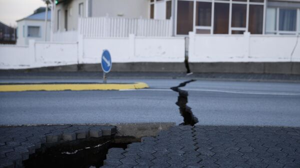 A fissure stretches across a road in the town of Grindavik, Iceland Monday Nov. 13, 2023 following seismic activity. - Sputnik International