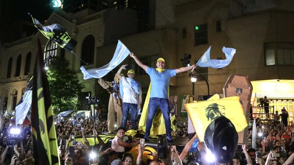Supporters of the Argentine presidential candidate for the La Libertad Avanza alliance, Javier Milei, celebrate his victory in the presidential election runoff outside the party headquarters in Buenos Aires on November 19, 2023 - Sputnik International