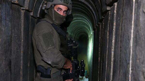 A soldier stands in what the Israeli army says is a tunnel dug by Hamas militants inside the Al-Shifa hospital complex in Gaza City in the northern Gaza Strip, amid continuing battles between Israel and the Palestinian militant group Hamas, on November 22, 2023 - Sputnik International