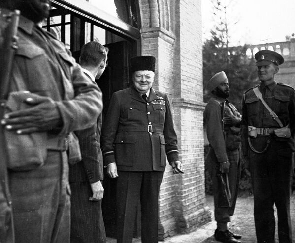 UK Prime Minister Winston Churchill wears a caracul (also called qaraqul) wool hat, given to him by the British press as a 69th birthday gift (November 30, 1943). Churchill is in Tehran at a conference with the US president and Soviet Leader. - Sputnik International