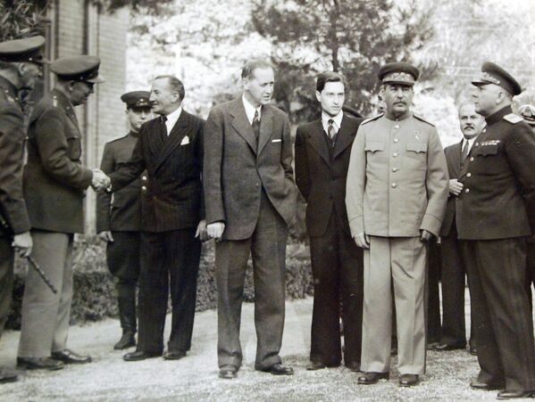 The Tehran Conference (November 28, 1943 – December 1, 1943). Standing outside the Soviet Embassy in Tehran, Iran are (left to right): a British officer; General George C. Marshall, chief of staff of the US Army (US), shaking hands with Sir Archibald Clark Keer, British Ambassador to the USSR (UK); Harry Hopkins, Joseph Stalin’s interpreter (US); Marshal Joseph Stalin (USSR); Vyacheslav Molotov, foreign premier of the Soviet Union (USSR); and Marshal Kliment Voroshilov, a prominent Soviet military officer (USSR). - Sputnik International