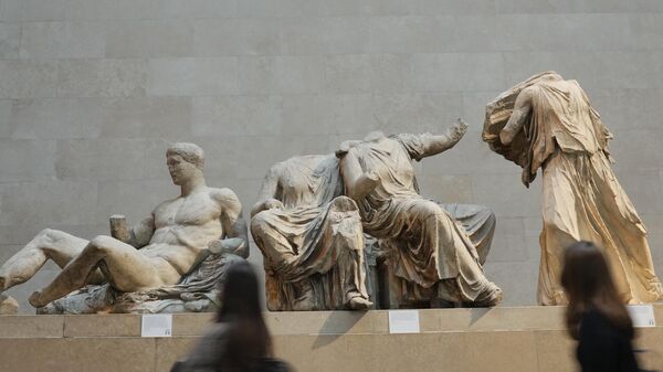 Visitors walk past sculptures that are part of the Parthenon Marbles at the British Museum in London, Tuesday, Nov. 28, 2023. Greek officials said Tuesday Nov. 28, 2023 that they will continue talks with the British Museum on bringing the Parthenon Marbles back to Athens, despite U.K. Prime Minister Rishi Sunak cancelling a meeting with his Greek counterpart where the contested antiquities were due to be discussed. - Sputnik International