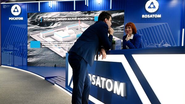 People gather at the stand of Russian State Atomic Energy Corporation Rosatom  - Sputnik International