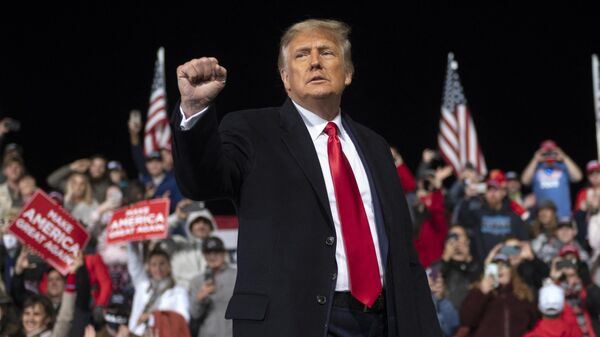 US President Donald Trump holds up his fist as he leaves the stage at the end of a rally to support Republican Senate candidates at Valdosta Regional Airport in Valdosta, Georgia on December 5, 2020 - Sputnik International