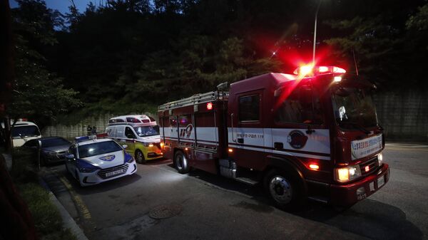 Fire, ambulance and police vehicles are seen in front of a park in Seoul, South Korea - Sputnik International
