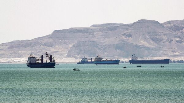 This picture taken on March 28, 2021 shows tanker and freight ships near the entrance of the Suez Canal, by Egypt's Red Sea port city of Suez. - Sputnik International