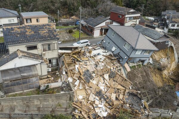 This aerial photo shows damaged and destroyed homes along a street in Wajima. - Sputnik International