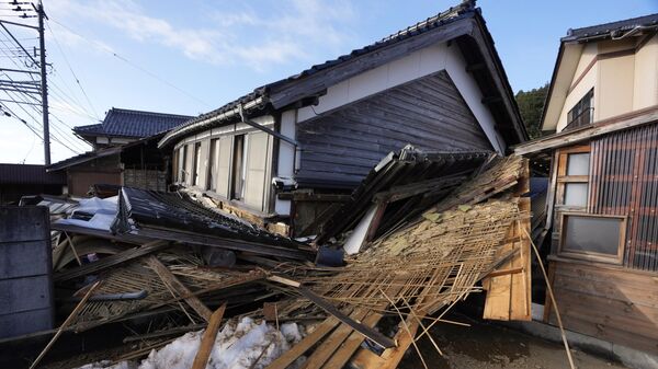A two-story house with its first floor collapsed caused by powerful earthquake is seen Tuesday, Jan. 2, 2024, near Nanao, Ishikawa Prefecture, Japan. - Sputnik International
