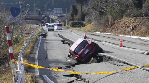 A car is trapped at a partially collapsed road caused by a powerful earthquake near Anamizu Town, Ishikawa Prefecture Tuesday, Jan. 2, 2024. - Sputnik International