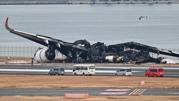 The burnt wreckage of a Japan Airlines (JAL) passenger plane on the tarmac at Tokyo International Airport at Haneda in Tokyo on January 3, 2024, the morning after the JAL airliner hit a smaller coast guard plane on the ground.
Richard A. Brooks / AFP - Sputnik International