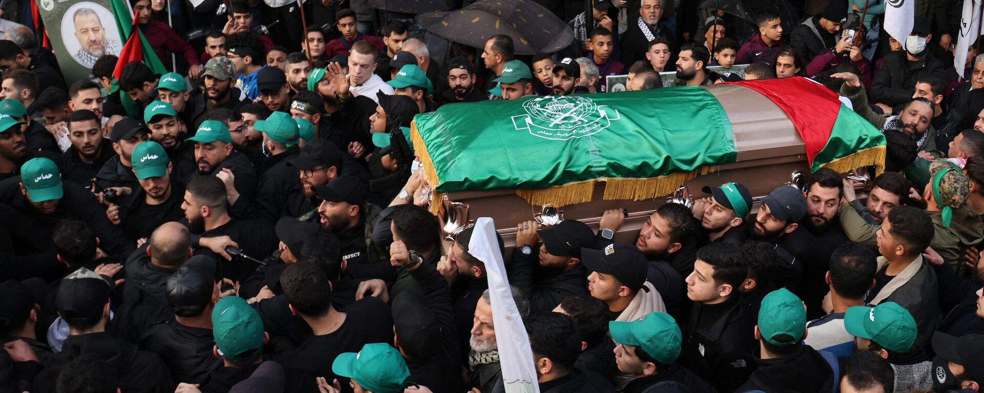 Mourners carry the coffin of Hamas' deputy leader, Saleh al-Aruri (portrait-R), killed on January 2 in a strike in Beirut's southern suburbs, during his funeral procession in Lebanon's capital on January 4. Lebanese authorities and Hamas accused Israel of killing Hamas leader al-Aruri and other officials, with Lebanese state media saying they died in a drone strike.  - Sputnik International, 1920, 07.01.2024