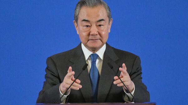 China's Foreign Minister Wang Yi attends a seminar on International Situation and China's Diplomacy in 2023, at the Diaoyutai State Guest House in Beijing on January 9, 2024.  - Sputnik International